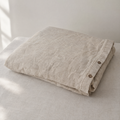Oat stonewashed linen duvet cover, folded