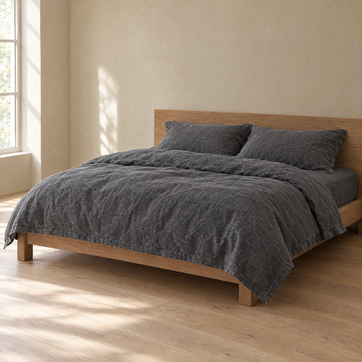 Bed made with a Charcoal linen duvet cover in a plain bedroom